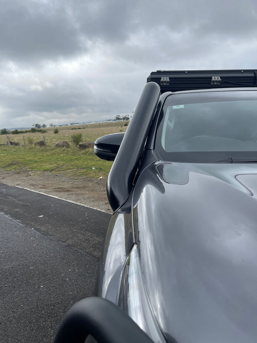 Close-up of the Canna Fabrication short-entry snorkel on a white Toyota Hilux N80